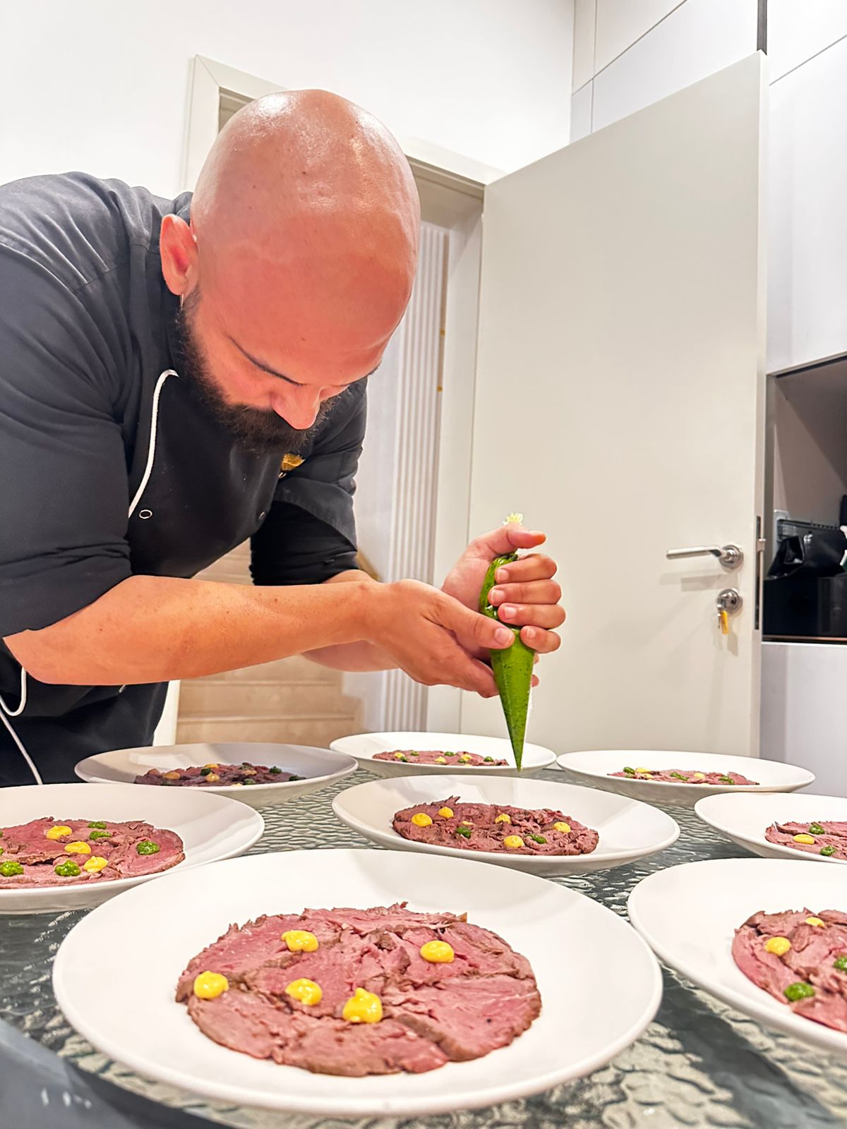 Chef Antonino plating dishes during a private dining experience in Dubai